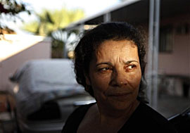 Pasquala Beaza looks on while watering her plants in front of home  at an unpermitted mobile home park in Thermal, Calif. Squalid housing  for migrant farmworkers has for decades been a depressing reality in  many places where crops are grown.