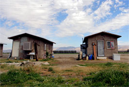 Farmworkers housing conditions in Coachella Valley, California.  Photo by David Bacon.