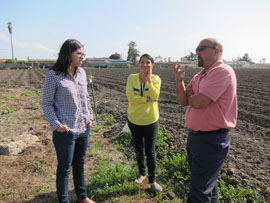 Jeanette Pantoja and Kenia Acevedo speak with Don Rosa, General Manager of the Pajaro/Sunny Mesa Community Services District, about the history of the well and surrounding fields. Photo by Amy Quinton 